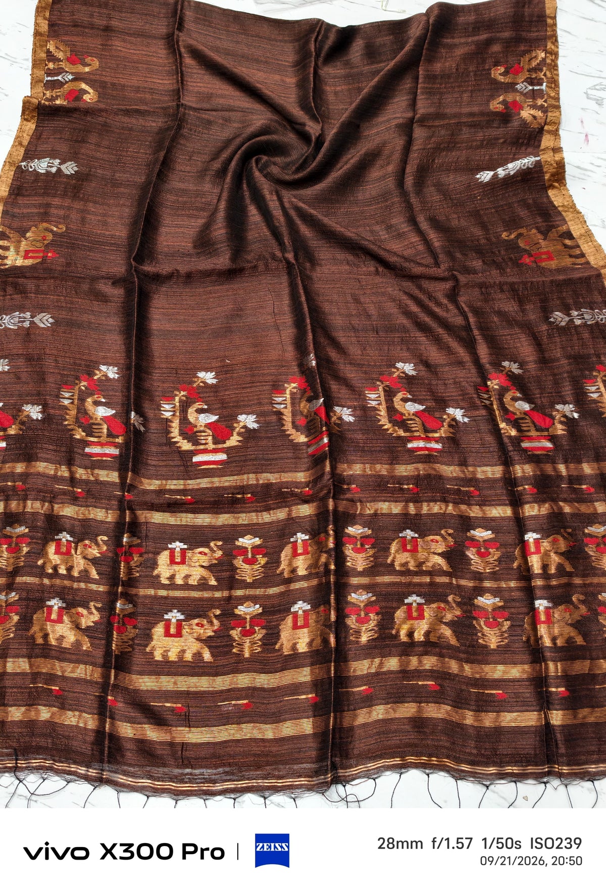 Swarnim Dark brown pure zari Meenakari Matka saree by Rihyaaz Fashions featuring traditional Meenakari detailing and elegant zari work, perfect for festive wear, weddings and special occasions.