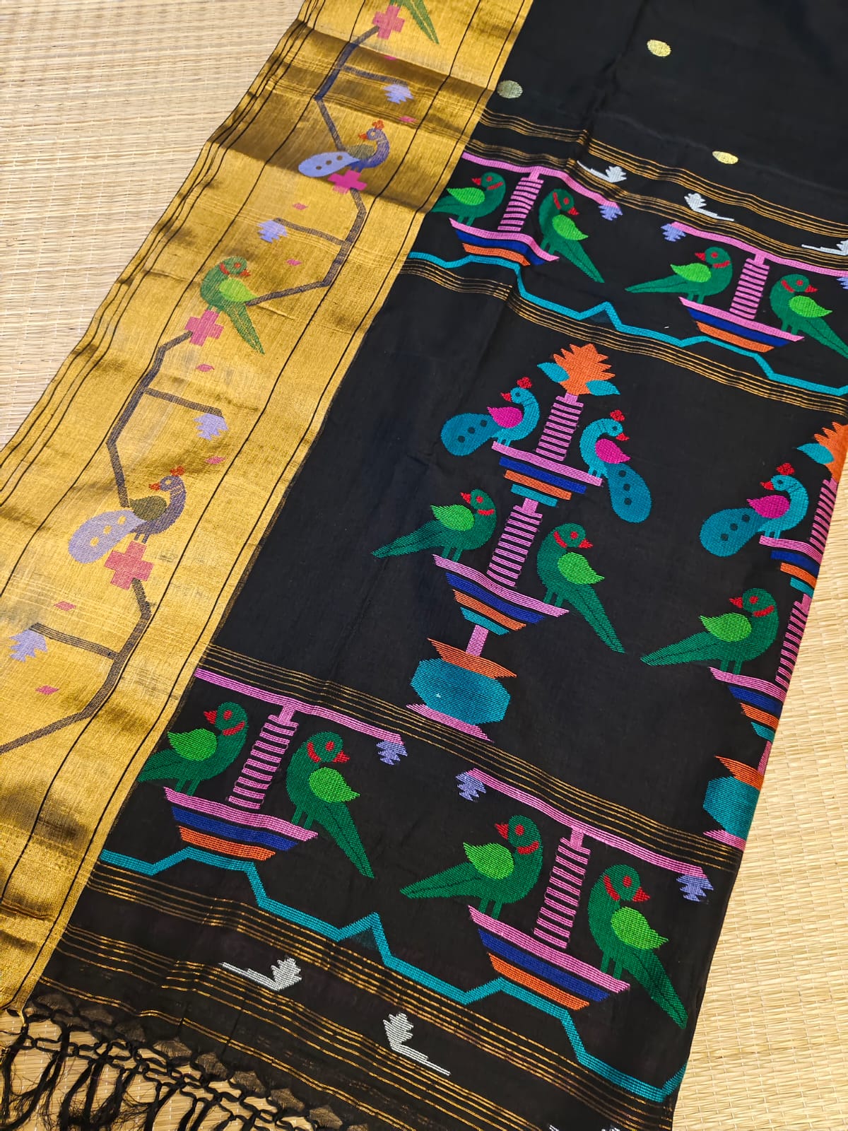 Traditional embroidered fabric with colorful patterns on a wooden surface