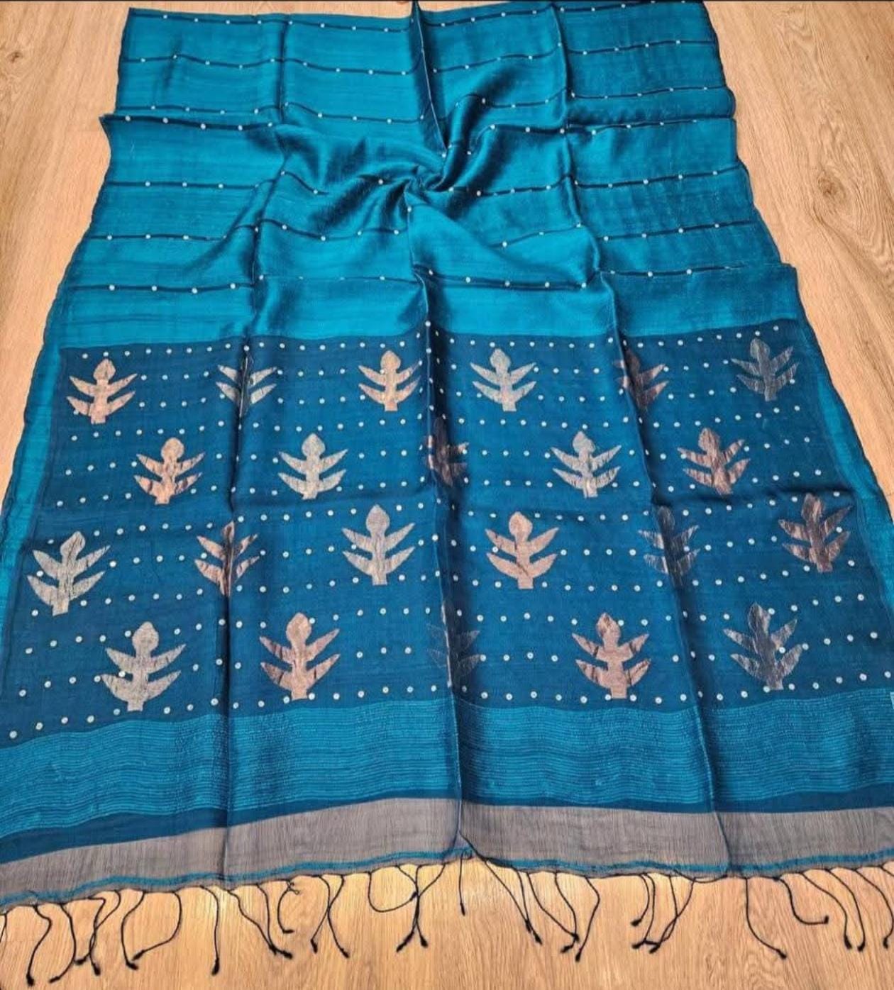 Taru Matka Muslin Silk saree with gold and silver zari motifs on pallu and white sequin sea-shell weave on body and palla by Rihyaaz