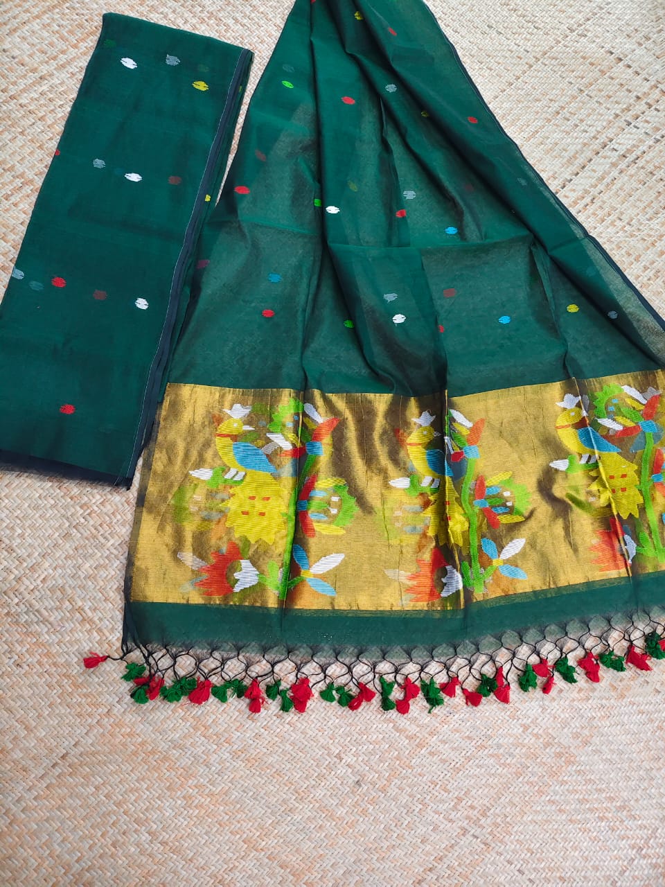 Morni bottle green premium muslin tissue suit with intricate needle work Jamdani palla Peacock Motif dupatta by Rihyaaz.
