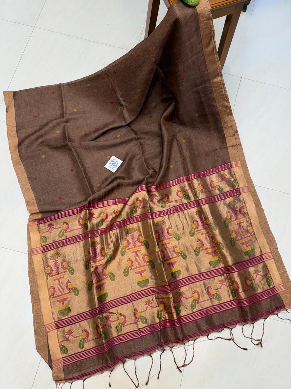 Morni Authentic premium-quality handloom saree crafted in soft pure Tissue Silk Linen with an elegant Paithani-inspired paired with a running blouse piece by Rihyaaz.