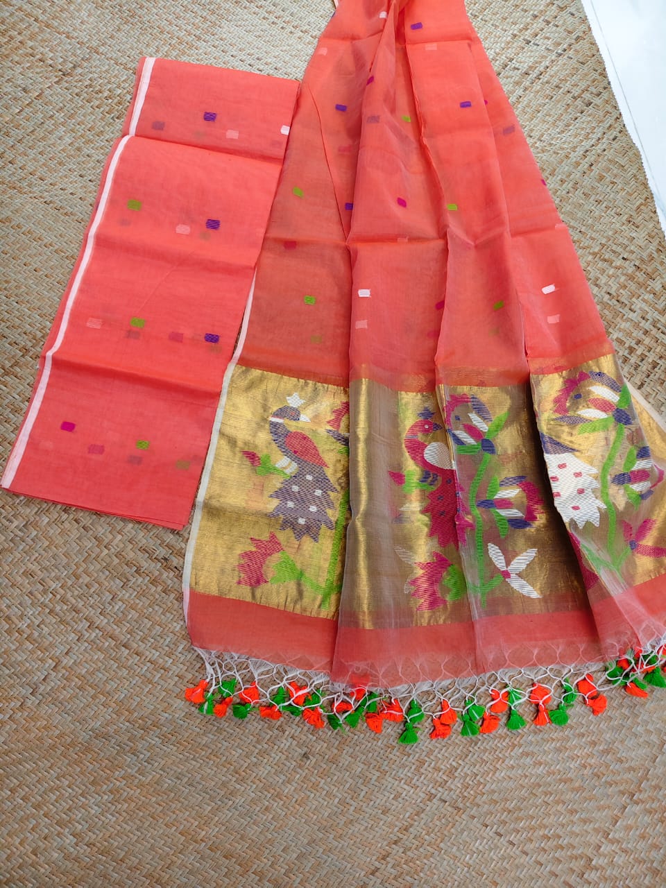Morni coral premium muslin tissue suit with intricate needle work Jamdani palla Peacock Motif dupatta by Rihyaaz.