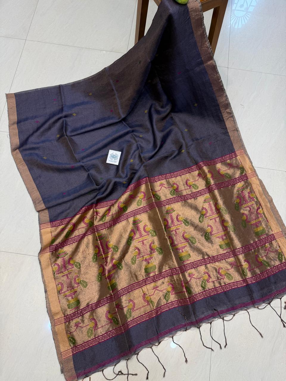 Morni Authentic premium-quality handloom saree crafted in soft pure Tissue Silk Linen with an elegant Paithani-inspired paired with a running blouse piece by Rihyaaz.