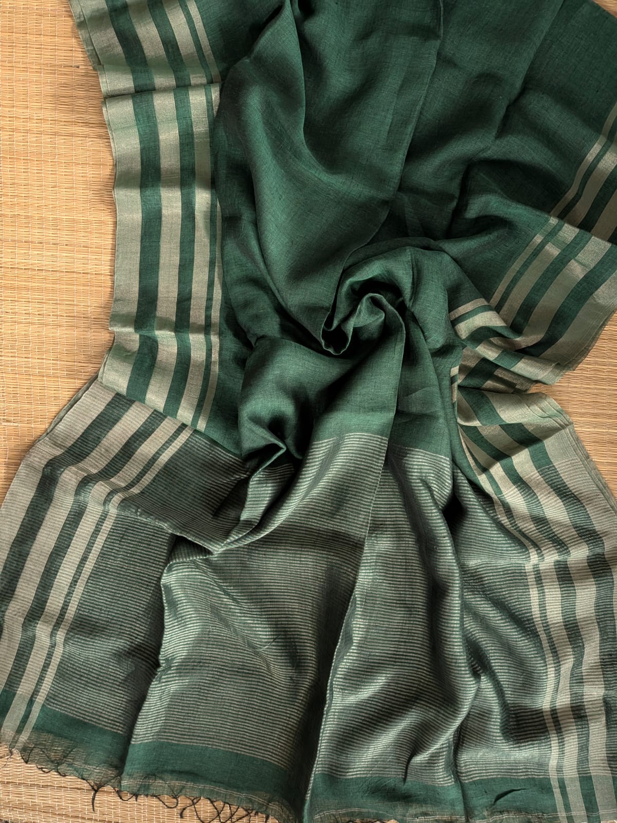 Dark green Pure 100-count Jayashree linen saree with tested zari double border on both sides and zari palla, including running blouse piece from Rihyaaz Fashions.