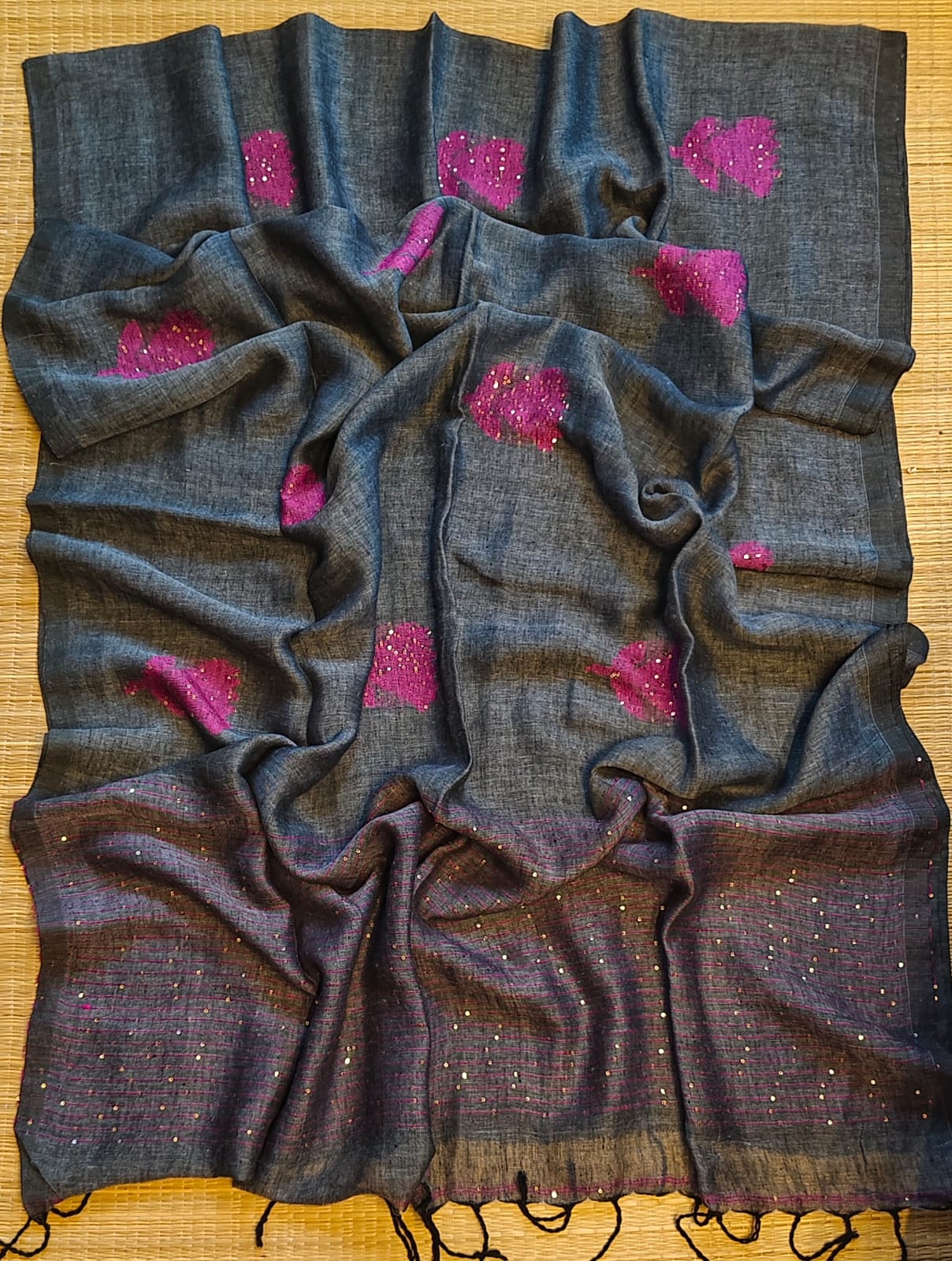 Shri Pure Linen by Linen handwoven floral motif Jamdani saree with sequence work on motifs and pallu, needlework butta and check blouse piece by Rihyaaz.