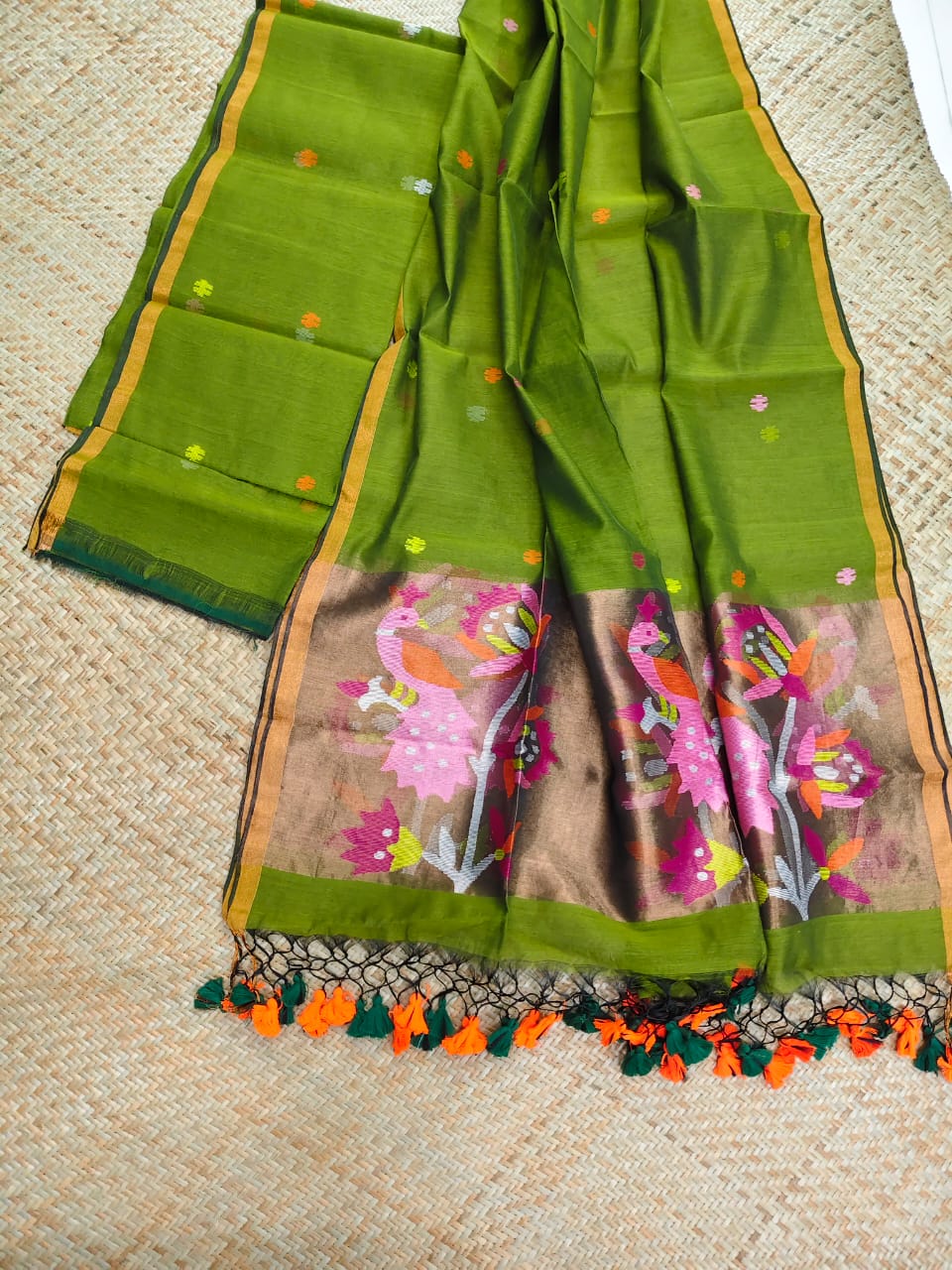 Morni green premium muslin tissue suit with intricate needle work Jamdani palla Peacock Motif dupatta by Rihyaaz.