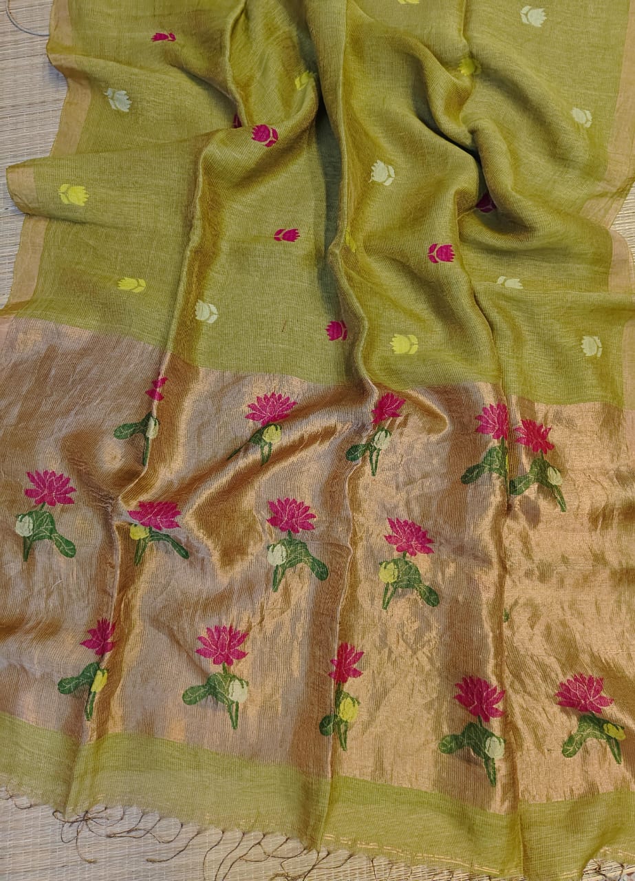 Green saree with floral embroidery on a beige background
