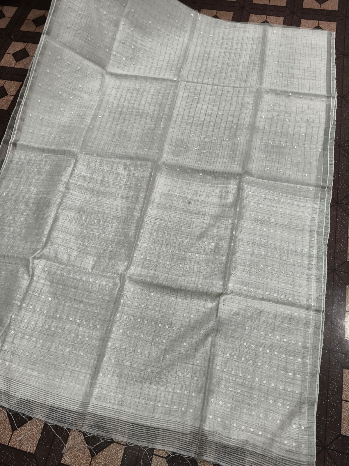 Shatranj Pure Matka Muslin Silk saree with zari border and all-over white sequin sea-shell woven palla, paired with running Matka blouse piece by Rihyaaz 