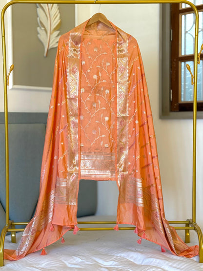 Exclusive Light Peach Banarasi raw mango silk unstitched salwar kameez with zari-woven top, woven silk dupatta and Silk Katan bottom by Rihyaaz.