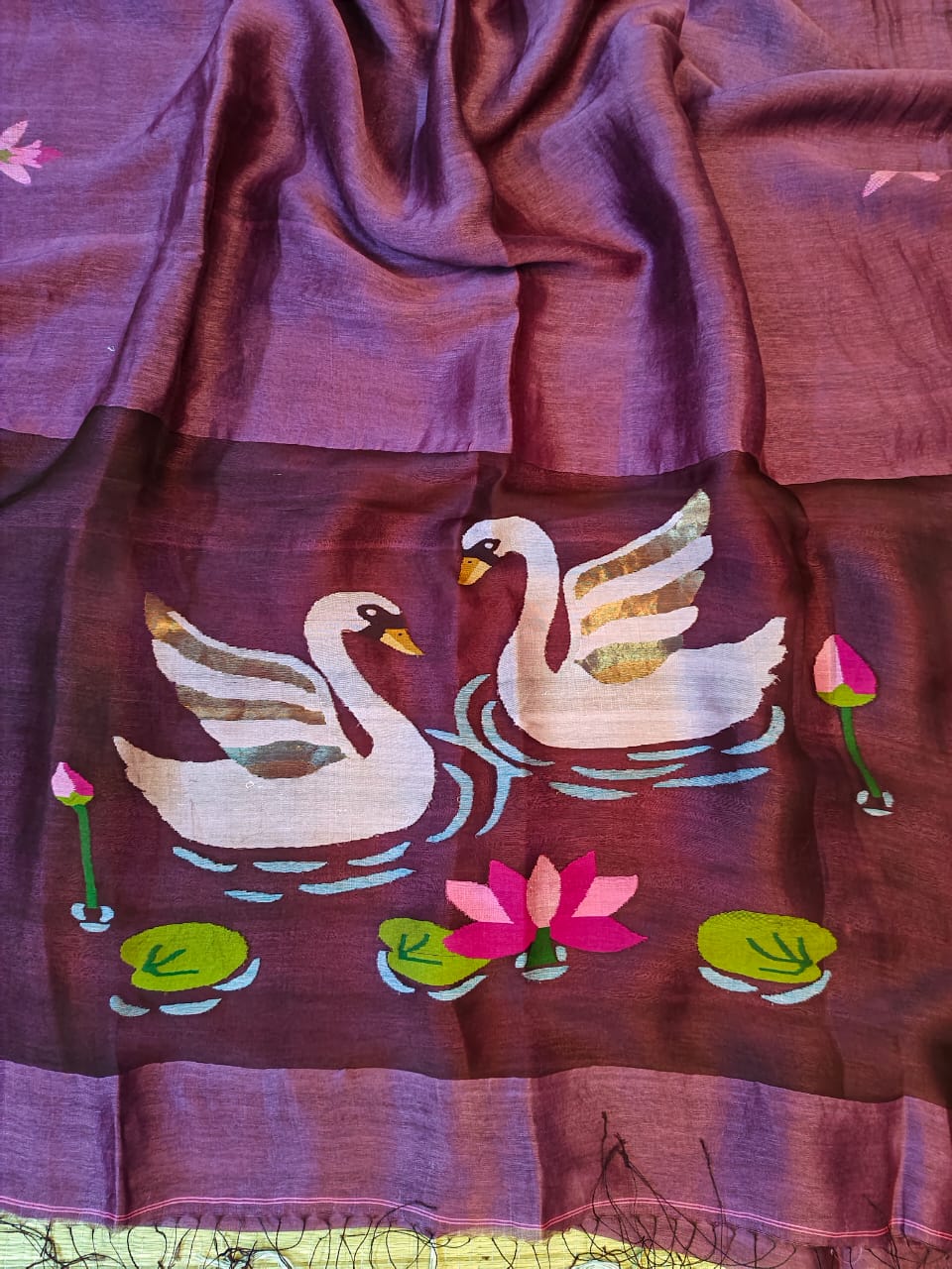 Purple fabric with embroidered swans and lilies