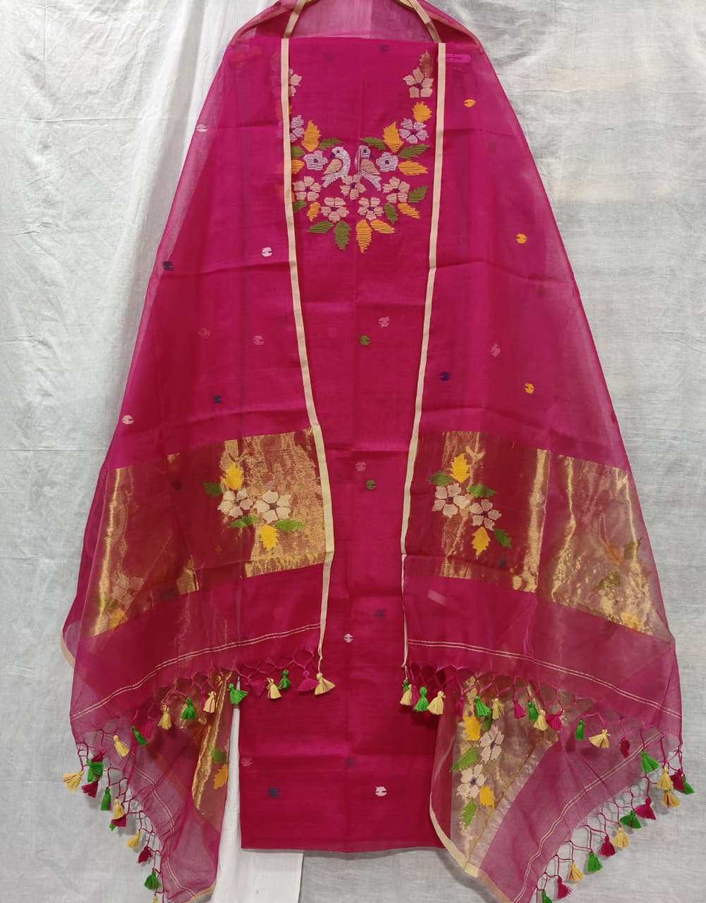 Rihyaaz Muslin Jamdani suit with matching tassel dupatta and delicate needle-weaved floral motifs.
