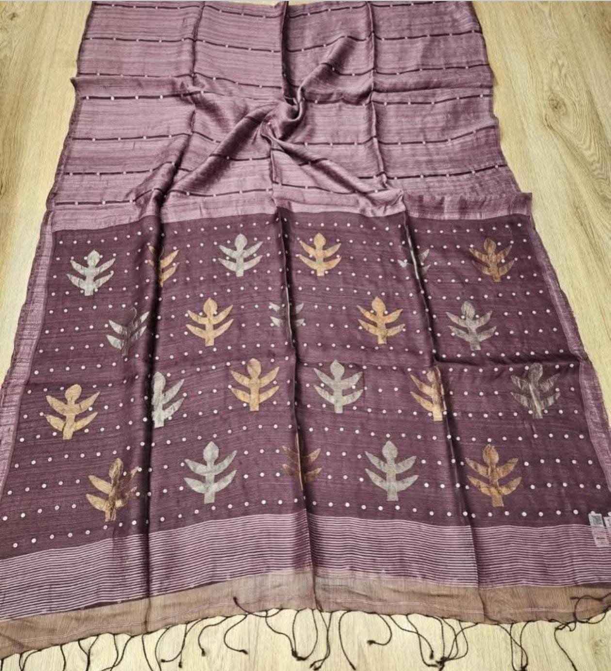 Taru Matka Muslin Silk saree with gold and silver zari motifs on pallu and white sequin sea-shell weave on body and palla by Rihyaaz