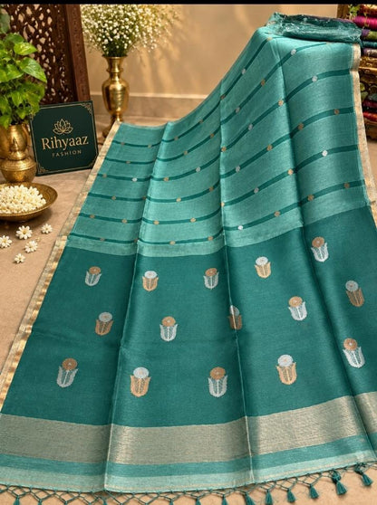 Shop Moss Mint Blue Silk Linen Resham Palla Sona Rupa Dual Zari Weaved Jamdani Saree by Rihyaaz. Handwoven heritage, refined detailing and timeless Indian elegance.