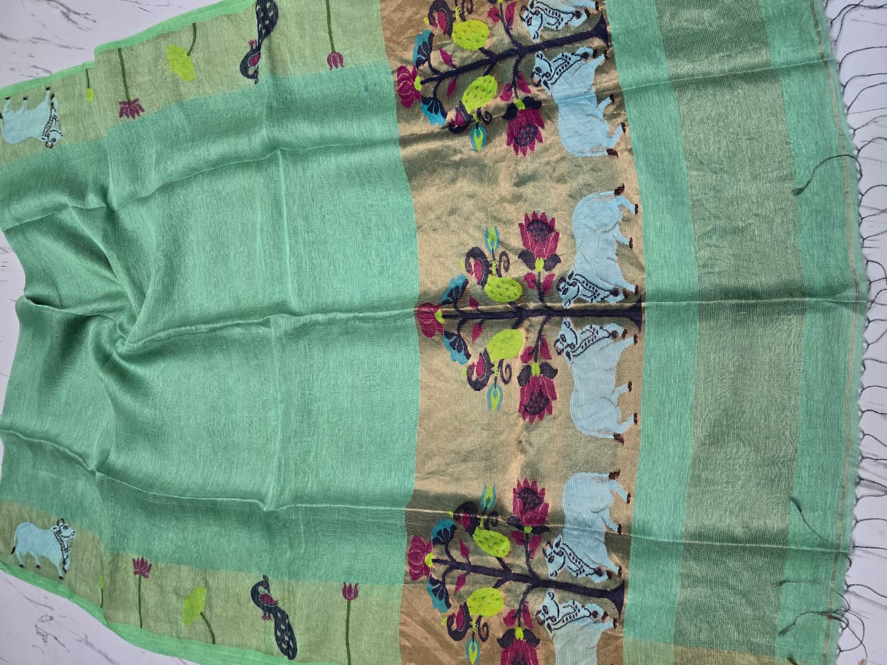 Suravi Silk Linen Pichwai Inspired Jamdani Saree by Rihyaaz featuring intricate handwoven Pichwai-inspired motifs on premium silk linen fabric, ideal for festive, wedding, and ethnic wear.