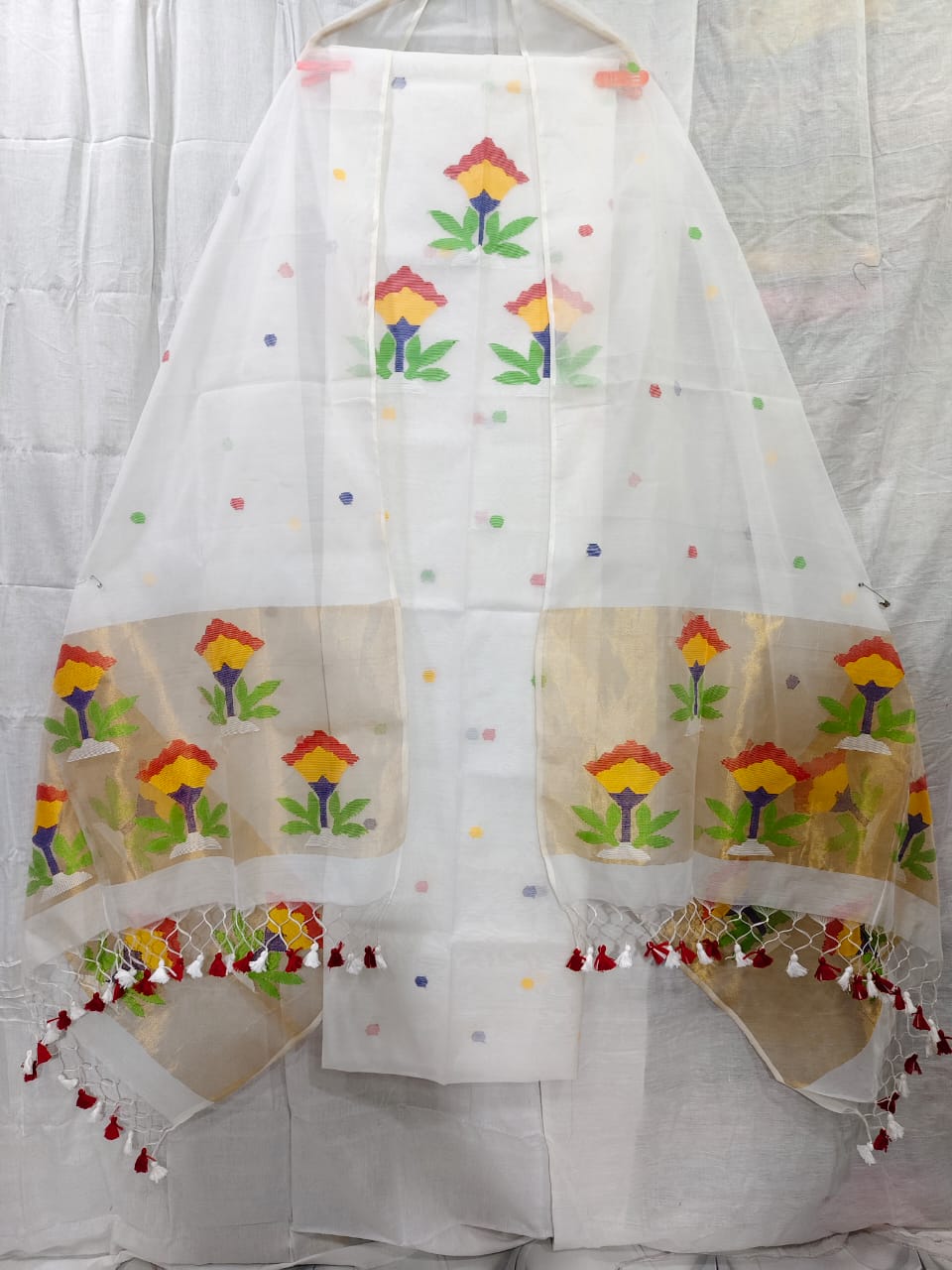 Rihyaaz muslin suit with 2.5 meter top and tasselled 2.5 meter dupatta, elegant ethnic Indian wear.