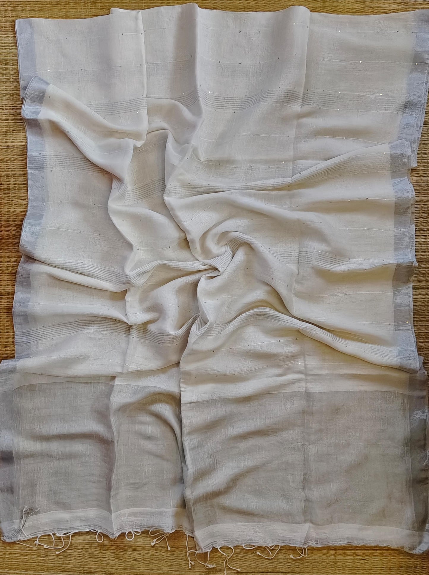 Pehal Premium Jayashree linen saree with tested zari pallu, sleek silver border, all-over sequin-line detailing and zari-striped blouse piece by Rihyaaz.
