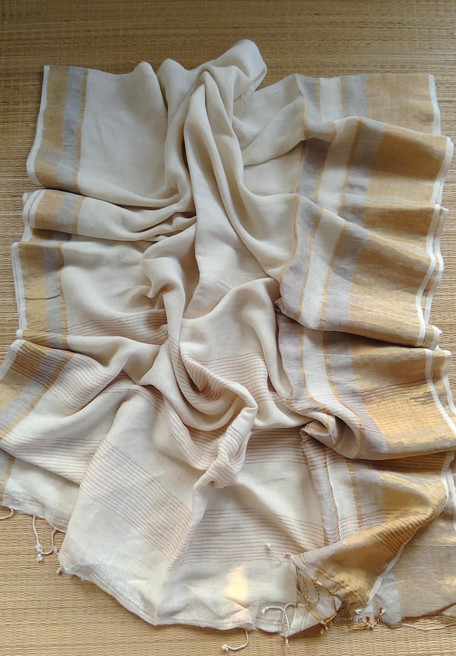 Revathi Pure Jayashree Linen handwoven saree with broad lower border, thin upper border, zari stripe pallu, and running blouse piece by Rihyaaz.