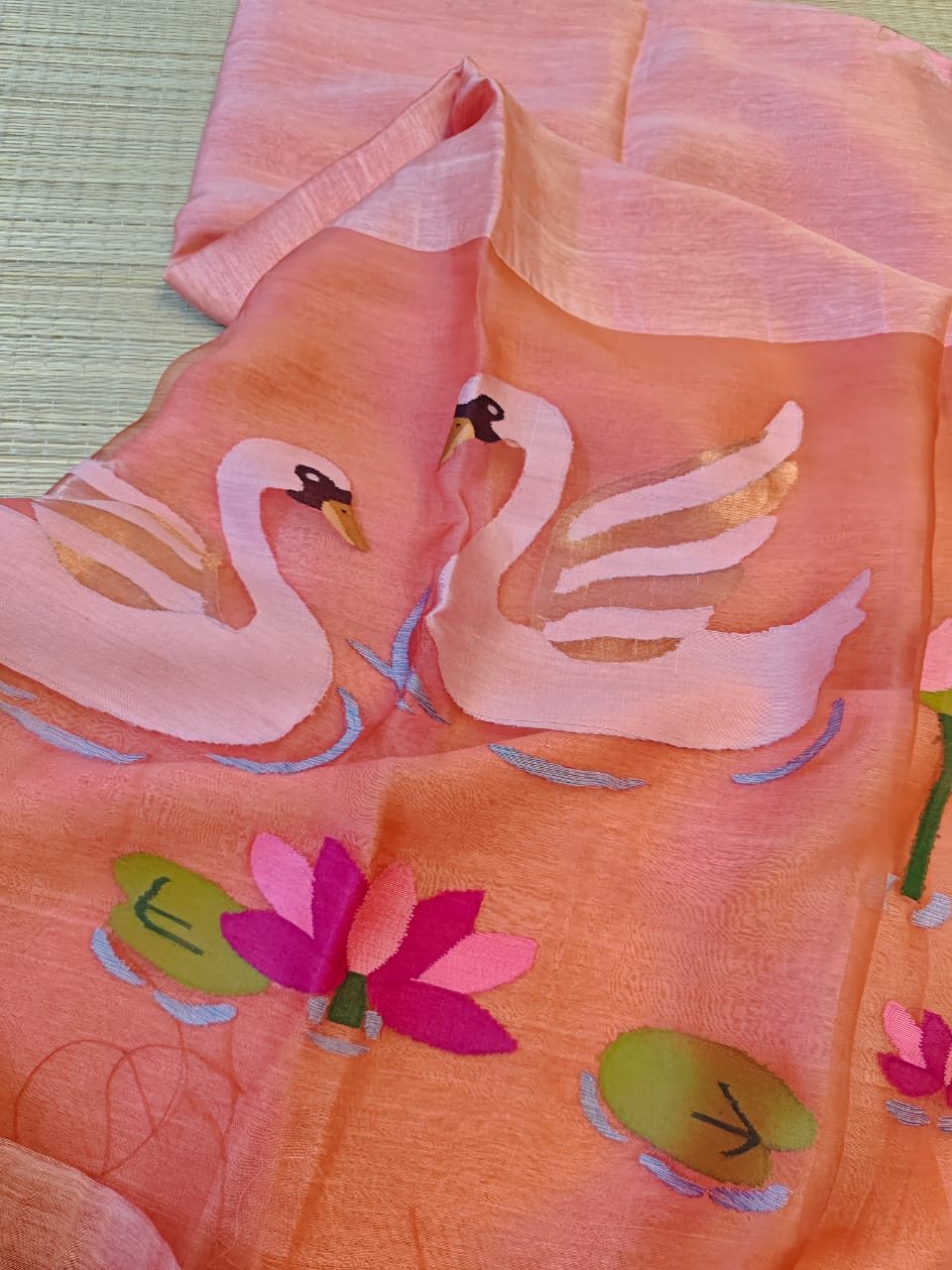 Peach fabric with swan and lily pad pattern