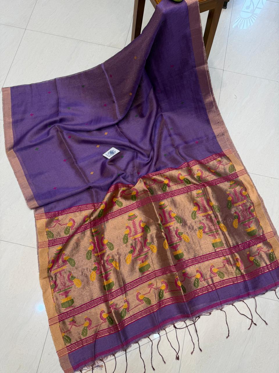 Morni Authentic premium-quality handloom saree crafted in soft pure Tissue Silk Linen with an elegant Paithani-inspired paired with a running blouse piece by Rihyaaz.