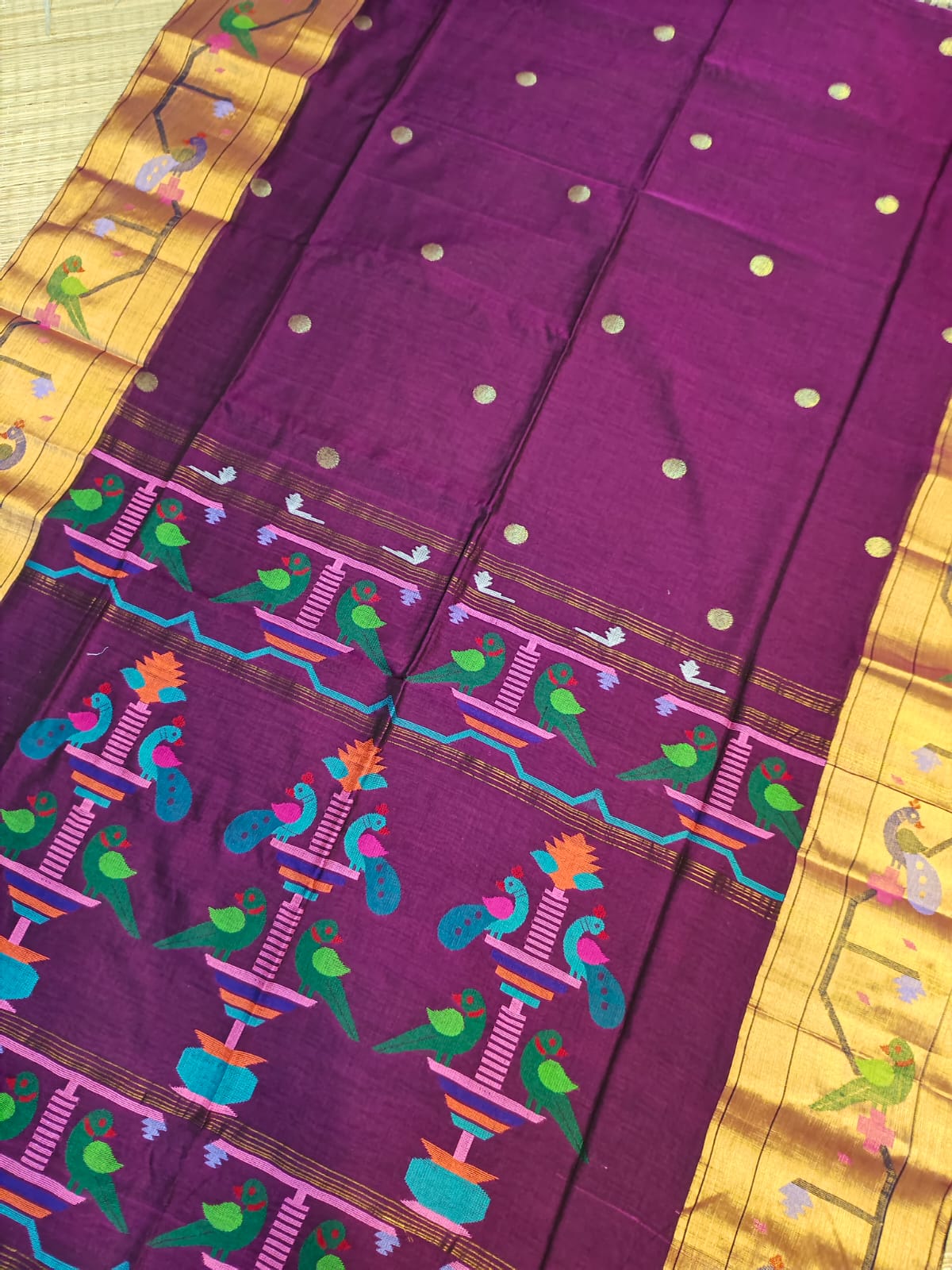 Purple fabric with colorful patterns on a yellow background