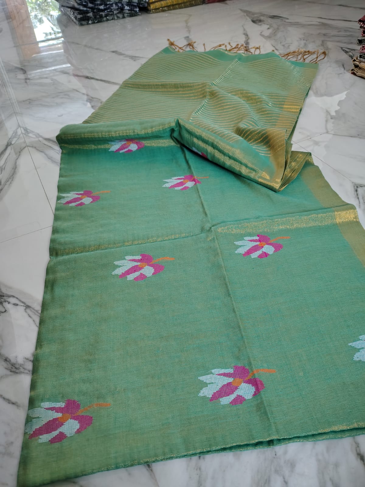 Lolita tissue linen allover weaved floral motiffs needle Jamdani saree with blouse piece, and striped zari weave in Pallu, handcrafted Bengali saree by Rihyaaz