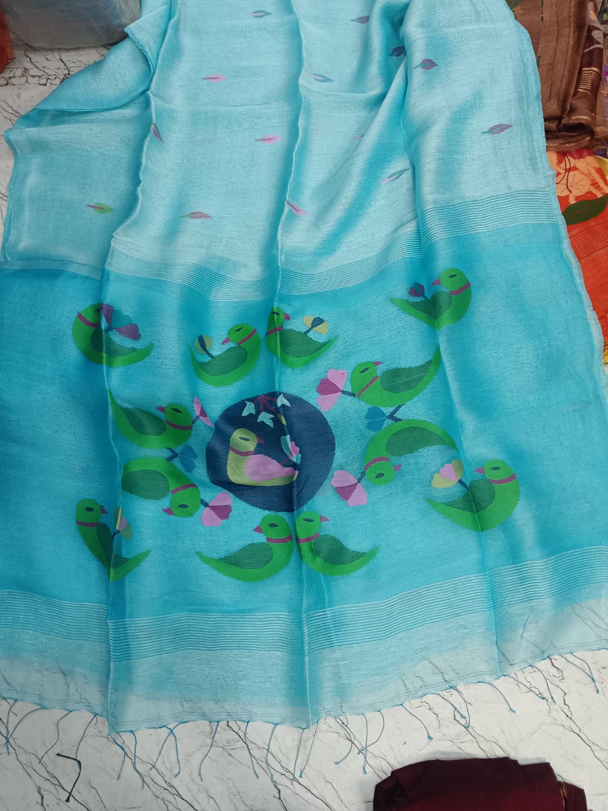Parrot - Silk Linen Needle Jamdani Weaved Saree from Rihyaaz, crafted with delicate Jamdani-inspired needle weaving and parrot motiffs. Its lightweight silk-linen texture and refined detailing make it an elegant choice for festive occasions, celebrations, and sophisticated everyday dressing.