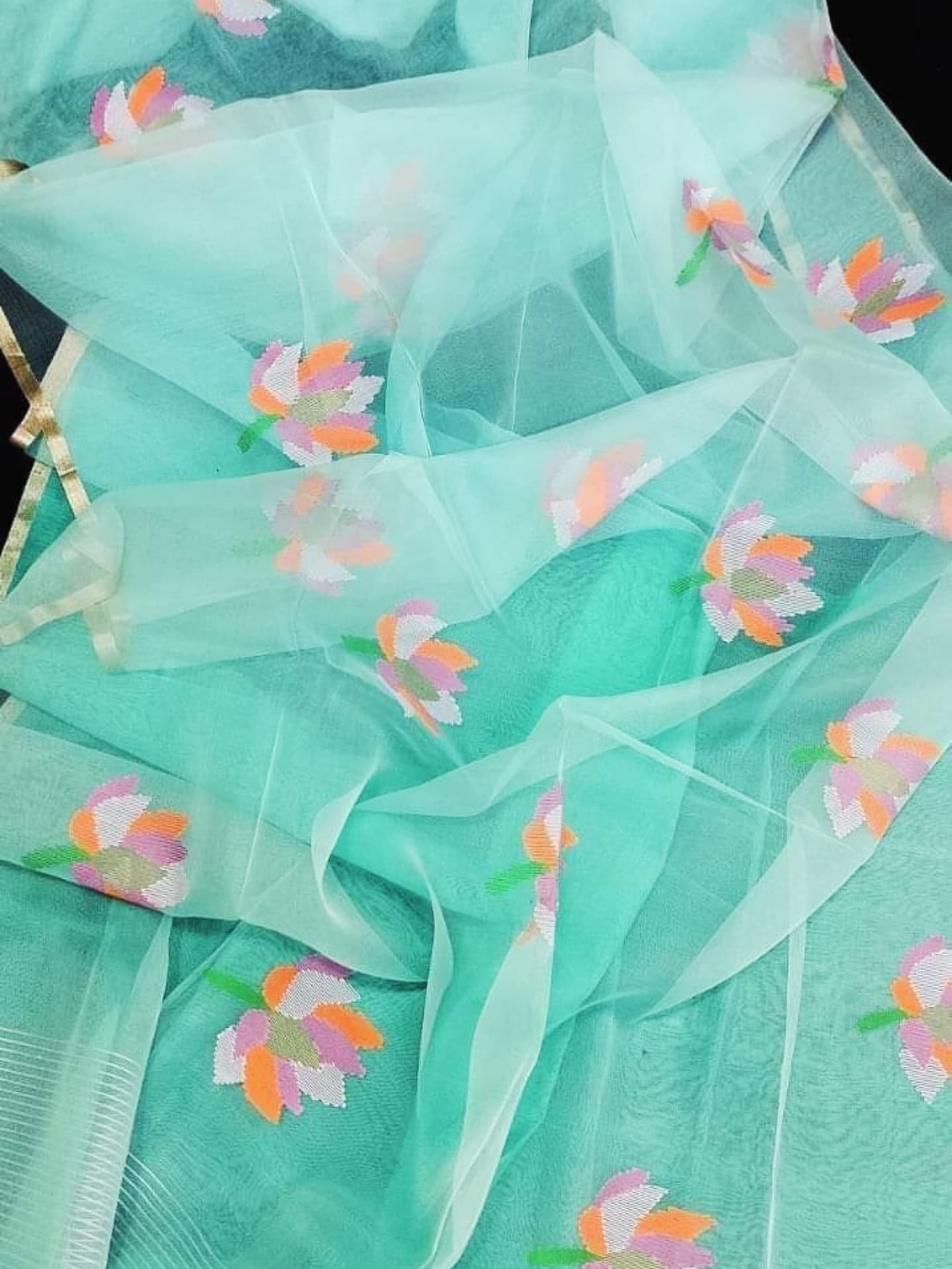 Nalina - Muslin Needle Jamdani Lotus Saree by Rihyaaz featuring handwoven lotus motifs on soft muslin fabric with intricate needle Jamdani craftsmanship.