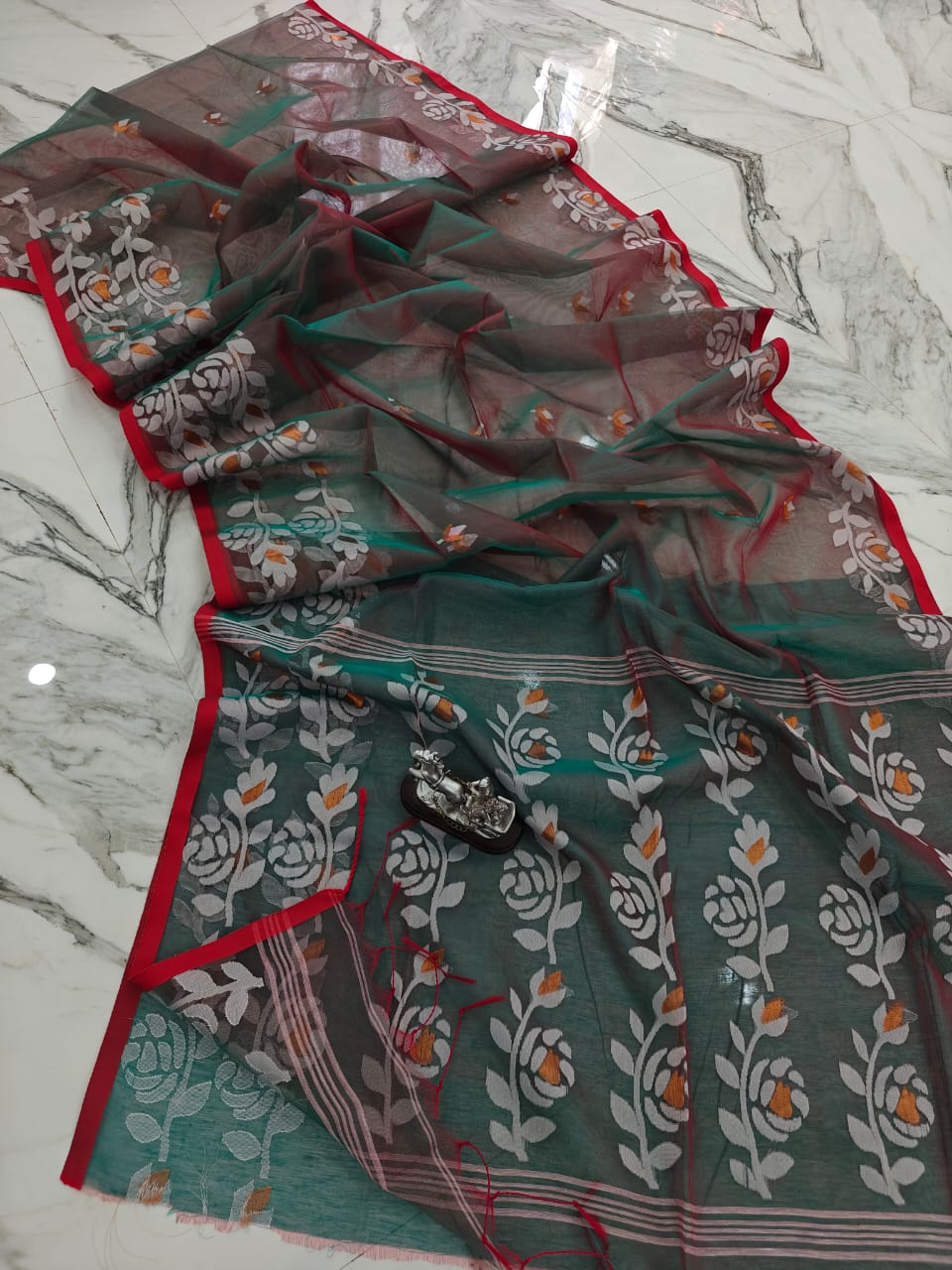 Muslin jacquard weaving saree by Rihyaaz featuring intricate woven patterns and an elegant lightweight drape.