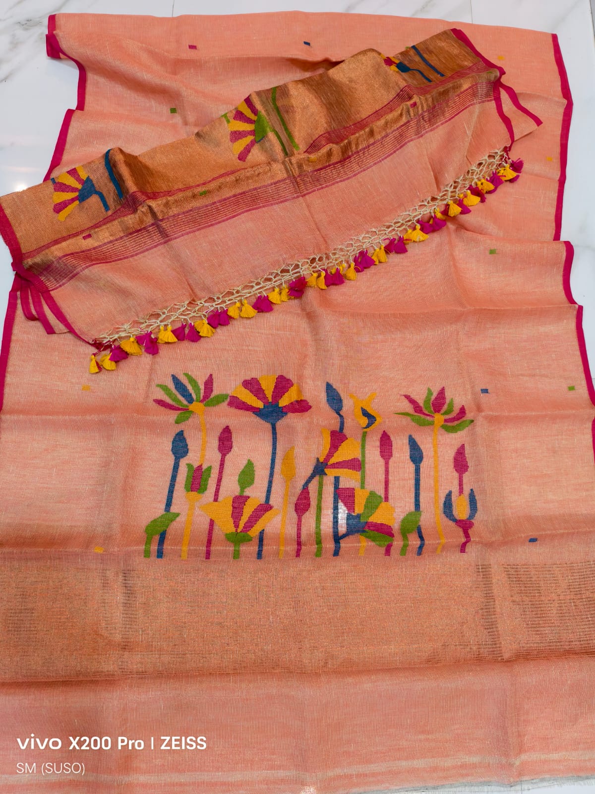 Tissue linen Pichwai weave Jamdani suit with dama detailing and zari palla, paired with floral-woven dupatta featuring zari border by Rihyaaz.