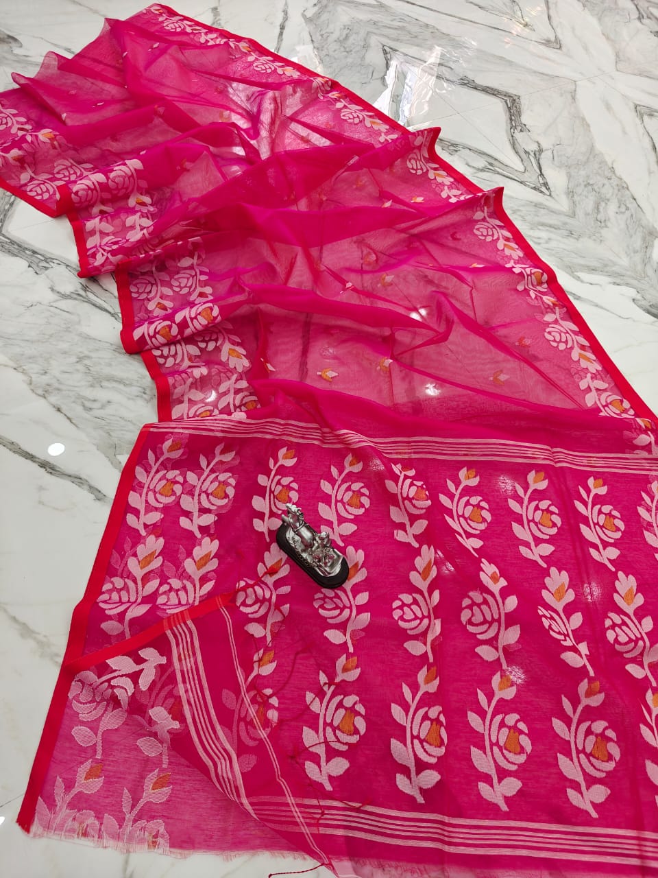 Muslin jacquard weaving saree by Rihyaaz featuring intricate woven patterns and an elegant lightweight drape.