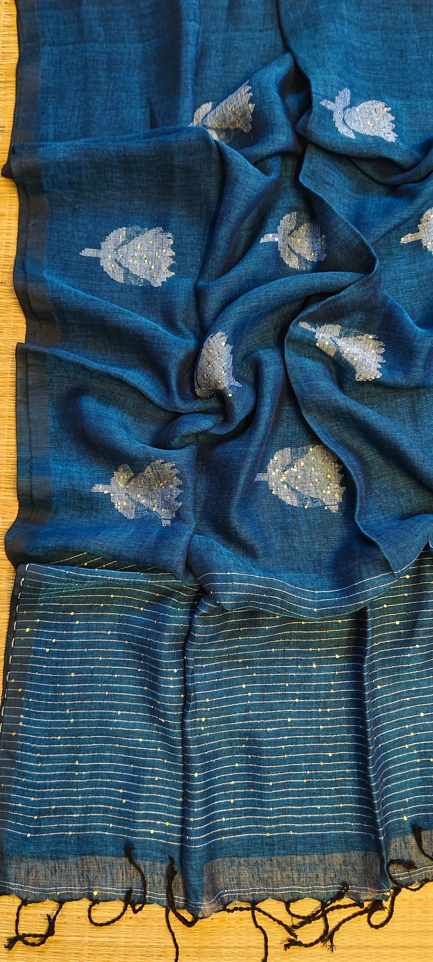 Shri Pure Linen by Linen handwoven floral motif Jamdani saree with sequence work on motifs and pallu, needlework butta and check blouse piece by Rihyaaz.