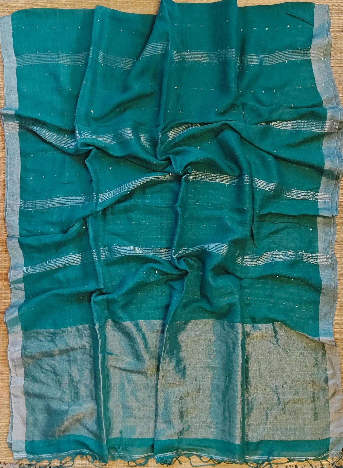 Pehal Premium Jayashree linen saree with tested zari pallu, sleek silver border, all-over sequin-line detailing and zari-striped blouse piece by Rihyaaz.