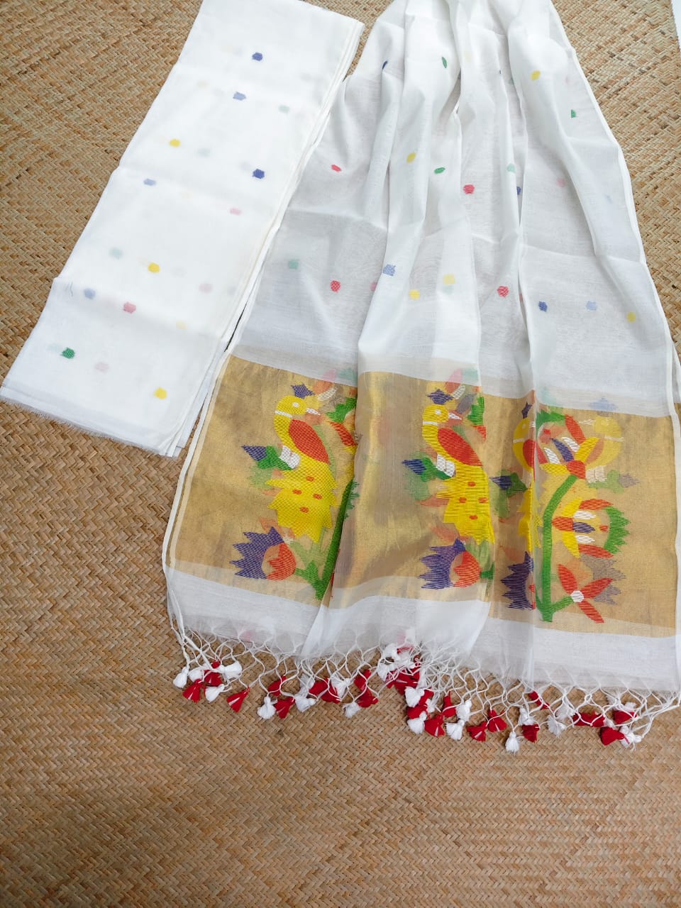 Morni white premium muslin tissue suit with intricate needle work Jamdani palla Peacock Motif dupatta by Rihyaaz.