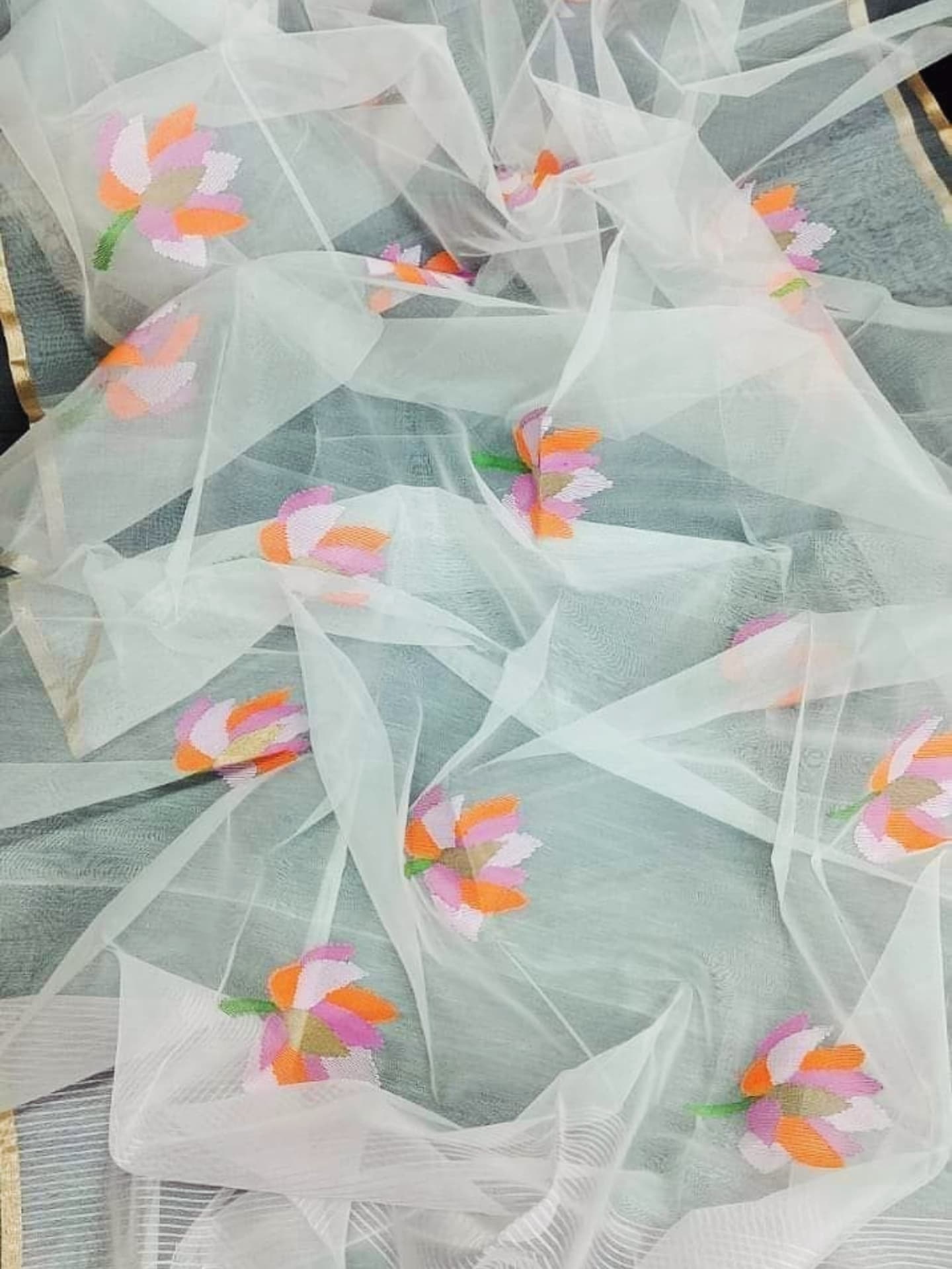 Nalina - Muslin Needle Jamdani Lotus Saree by Rihyaaz featuring handwoven lotus motifs on soft muslin fabric with intricate needle Jamdani craftsmanship.
