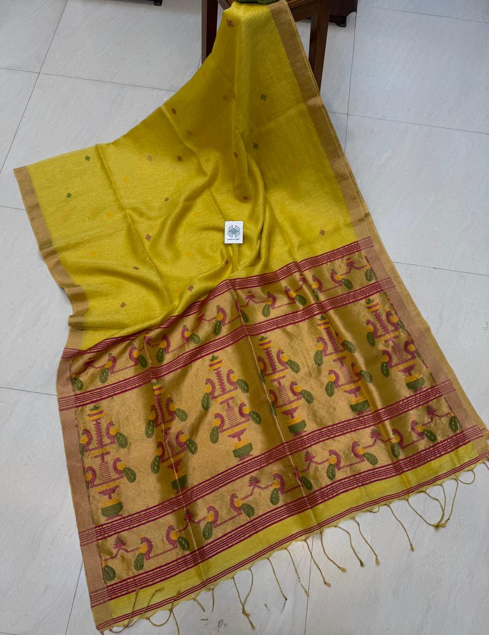 Morni Authentic premium-quality handloom saree crafted in soft pure Tissue Silk Linen with an elegant Paithani-inspired paired with a running blouse piece by Rihyaaz.