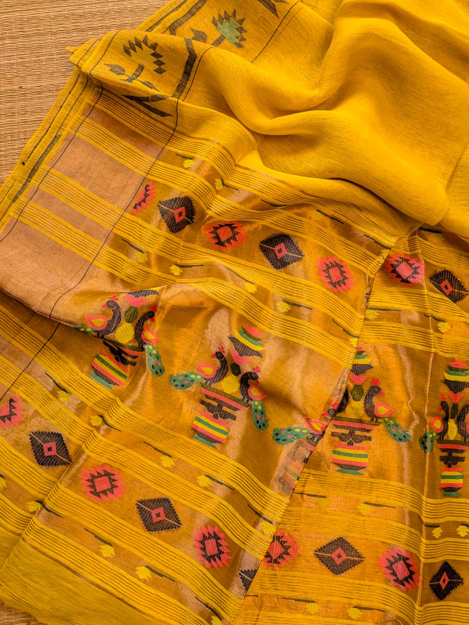 Iravati Yellow exclusive silk linen saree featuring a tested zari Jamdani border, elegant Paithani-style tissue pallu, and matching running blouse piece by Rihyaaz Fashions.