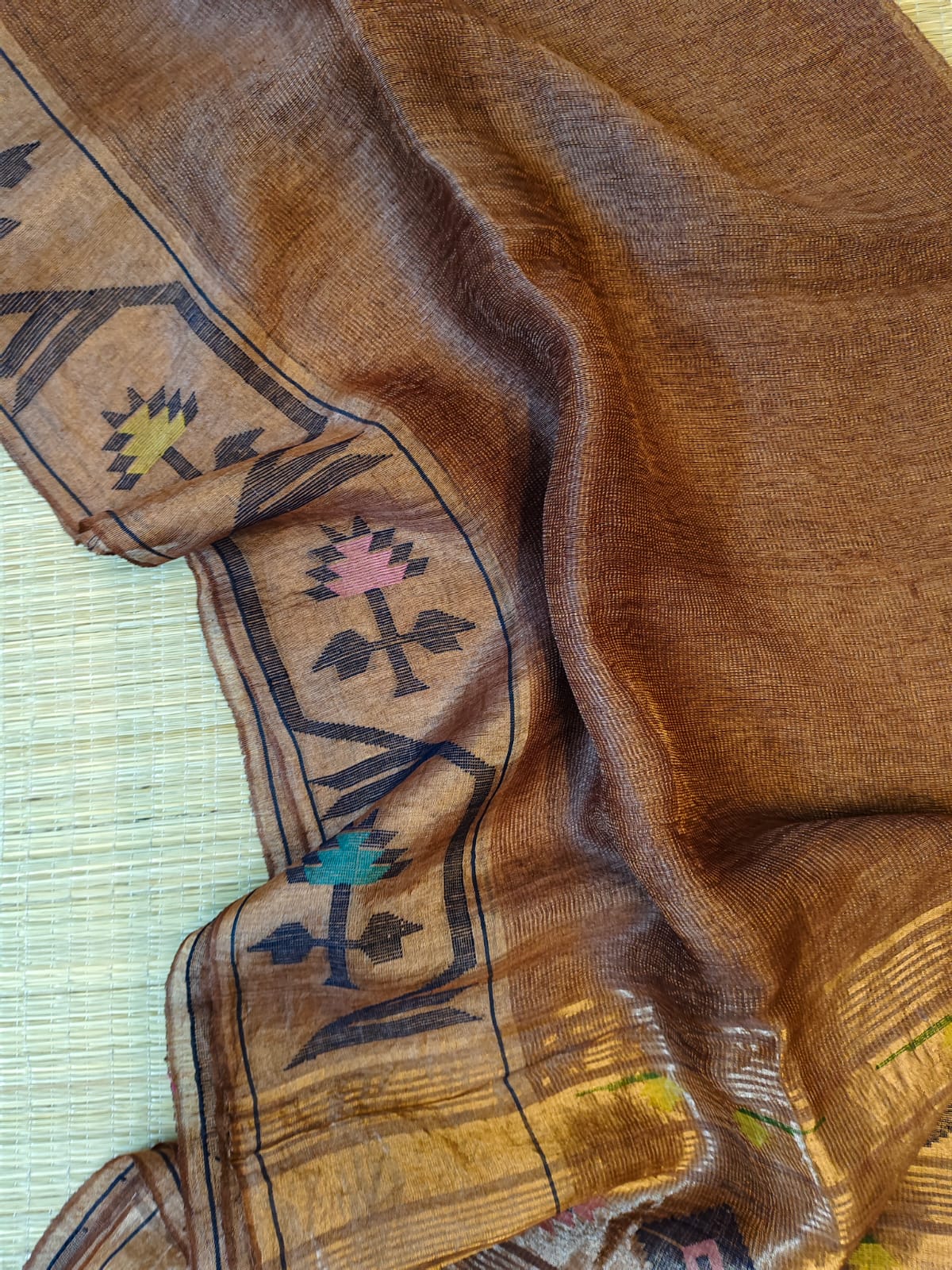 Iravati Dark brown exclusive silk linen saree featuring a tested zari Jamdani border, elegant Paithani-style tissue pallu, and matching running blouse piece by Rihyaaz Fashions.